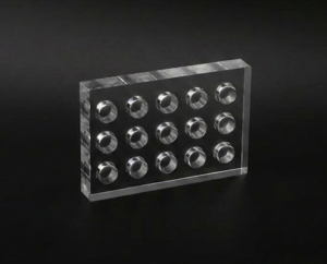 CNC machined clear acrylic block with precision counter-bore hole array
